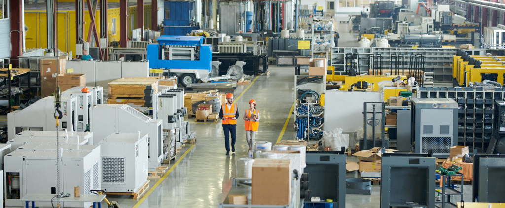 A factory with many workers working on machines.