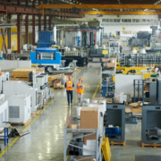 A factory with many workers working on machines.