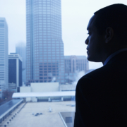 A man in a suit looking out of the window